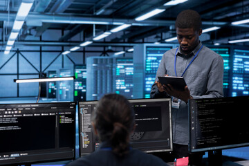 Engineer in data center running system diagnostic tests and error checking utilities to identify...