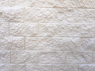 Beige Brick Wall with Clean Concrete Sidewalk