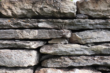 Gray stone blocks with soil and plants.


