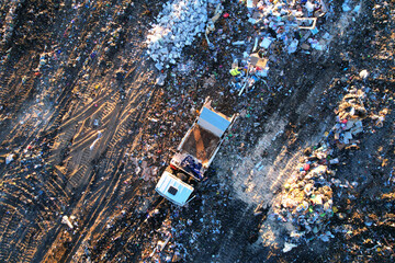 Landfill with waste disposal, aerial view. Garbage dump. Garbage truck unloads rubbish in landfill....