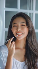Promoting Daily Oral Hygiene Practices With a Young Woman Brushing Her Teeth at Home