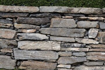 Gray stone blocks with soil and plants.

