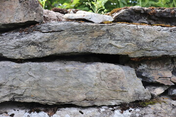 Gray stone blocks with soil and plants.

