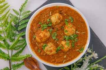 Anda Masala or Egg Curry is popular indian spicy food. Egg roast curry or Mutta roast gravy dish popular spicy South Indian food on isolated background Tamil Nadu South India. 