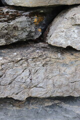 Gray stone blocks with soil and plants.

