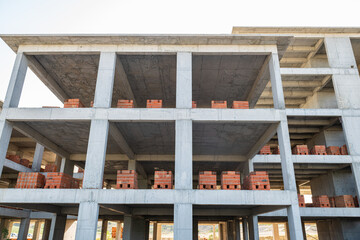 Unfinished concrete building on a construction site.