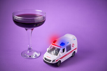 Toy ambulance with a glass of wine. Drunk driving concept and breathalyzer © Fabián Montaño