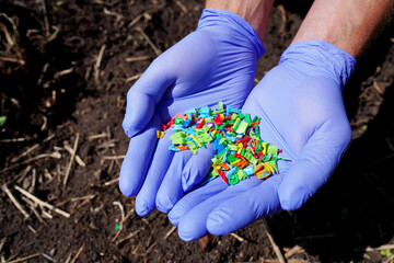 Microplastic pollution. Microplastics in ground. Soil contaminated with microplastics. Plastic...