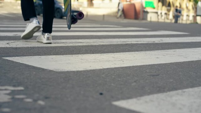close-up on road pedestrian crossing white stripes close-up of legs in white beauties crossing the road safe movement