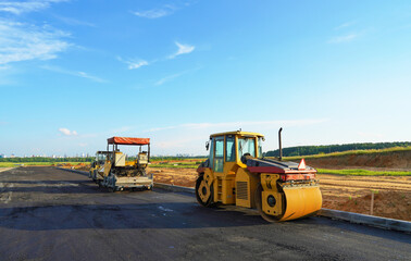 Asphalting paving repairing works. Vibrator compactor machine on roadworks on city street. Asphalt road roller on road construction. Road Construction Equipment. Vibration roller on Asphalting.