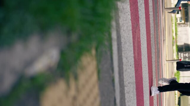 on road pedestrian crossing red and white stripes close-up of legs in white beauties crossing the road safe movement