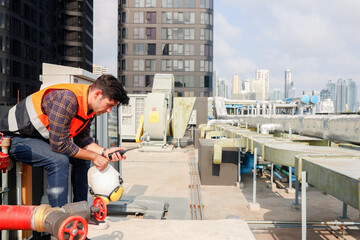 Male worker AVC refrigeration system technician works hotel building Inspect refrigeration...