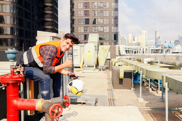 Male worker AVC refrigeration system technician works hotel building Inspect refrigeration equipment electrical control systems listening technicians in the call room by radio communication.