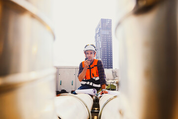 Architect engineer male who installs havc refrigeration equipment looking at blueprints on building...