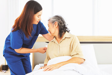 Obraz premium Female doctor nurse take care elderly female patient who is being treated for discomfort due congenital disease gently supporting her shoulder to help her sleep : Elderly health insurance.