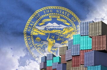 Nebraska US state flag and big stack of shipping cargo containers in docks with sky background...