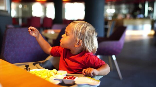 Mom feeds a little girl with pieces of meat, and she spits them out. High quality 4k footage
