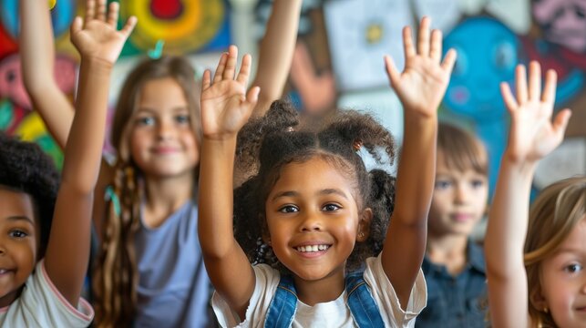 Happy elementary school teacher giving high-five to her student during class in the classroom.
