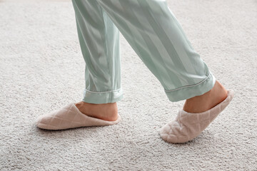 Woman in slippers walking on soft carpet. New beginning concept