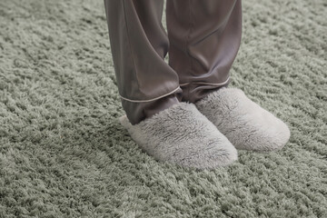 Woman in slippers standing on soft carpet. New beginning concept