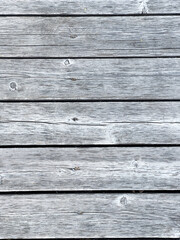 Close-up view of weathered, gray wooden planks