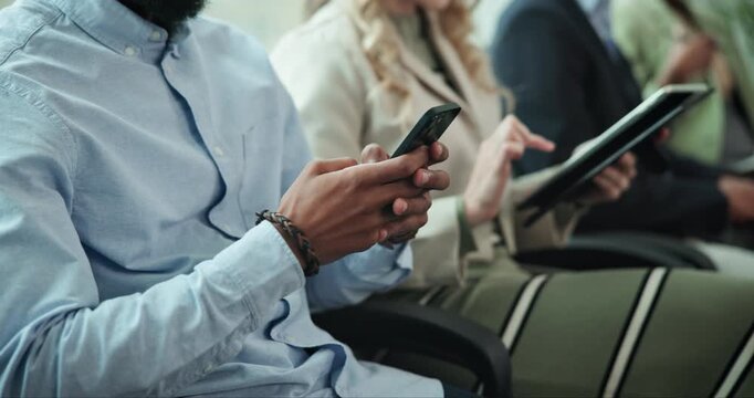Hands, people and technology in row for job interview at office with research, internet and networking. Closeup, candidates and waiting room for recruitment, hiring process and career opportunity