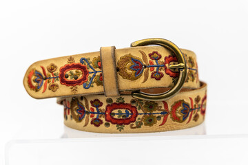 Flower Floral Embossed Real natural Leather belt. Leather brown belt on white background, vintage retro leather belt.