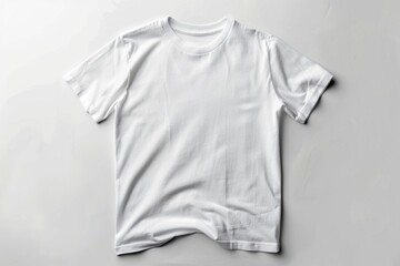A close-up view of a plain white t-shirt lying on a white surface