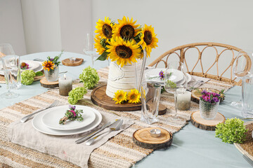 Served dining table with beautiful sunflowers, floral decor and candles