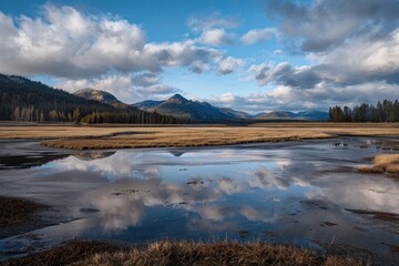 Stunning reflection of mountains and clouds in a calm lake