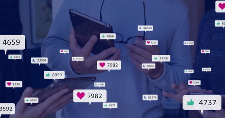 Image of social media notifications over midsection of caucasian colleagues using smartphones