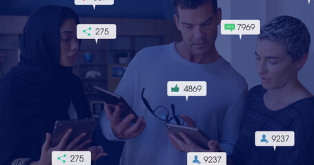 Image of social media notifications over diverse colleagues using tablets