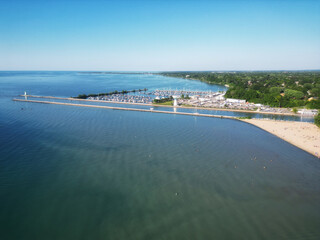 Aerial over Lakeside Park Beach in the Port Dalhousie area of St. Catharines, Ontario, Canada, on the south shore of Lake Ontario. Shot on a late summer afternoon in July, 2024.