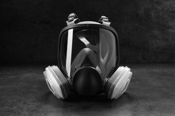 One full face respirator on dark background