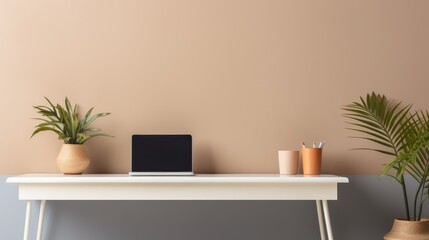Fototapeta premium Sleek desk with a minimalist laptop and potted plant