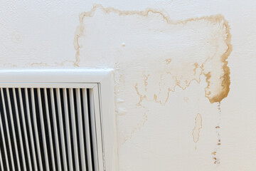 Ceiling stain and cracked and mold after air conditioner has water drop leak on air grille.