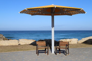 A canopy for protection from the hot sun in a city park.