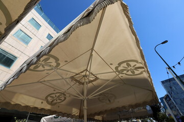 A canopy for protection from the hot sun in a city park.