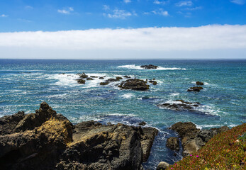 Pigeon Point shoreline with rocks and tide pools in Pescadero at summer time.