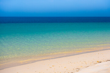 Nature of the beach and sea Summer with sunshine, sandy beaches, clear blue waters sparkling against the blue sky. On an island with good ecology and environment Background for summer vacation concept