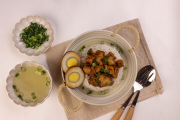 Nasi Bakmoy is Rice Topping with Sweet and Savory Chicken and Soup with Brown Boiled Egg.