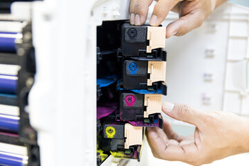 Technician replace ink cartridges of printer toner low and fix repair problem paper or print scanning fax or copy document or photocopier or photocopy office workplace equipment concept