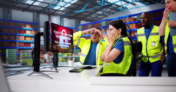 Shocked Engineers In Automated Logistics Warehouse During Ransomware