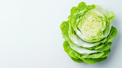 Fototapeta premium Slices of crisp, fresh iceberg lettuce arranged in a neat stack. The intricate leaf structure and subtle color gradient on a white background