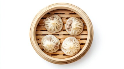 Steamed baozi dumplings filled with savory meat, top view in a bamboo steamer, isolated on white background for a clean look.