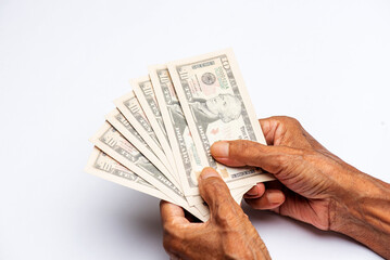 Counting US paper currency 10 dollar against white background