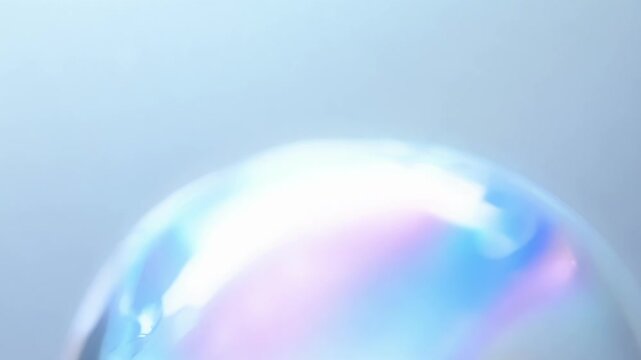 A slowmotion capture of a soap bubble popping revealing intricate patterns and swirls in its thin film.