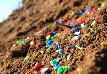 Microplastic pollution. Microplastics in ground. Soil contaminated with microplastics. Plastic...