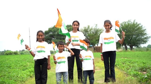 Group of happy Indian wearing traditional white dress holding indian flag celebrating Independence day or Republic day. Har Ghar Tiranga