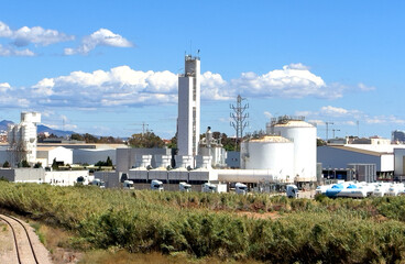 Oxygen plant in Port Sagunto, Spain. Cement factory in industrial area. Chimney smokestack...